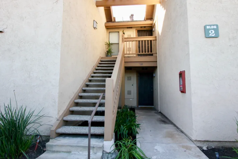THE HOUSE WITH PLANTS, STEPS, NUMBER BOARD ON THE WALL IN THE CITY OF IRVINE