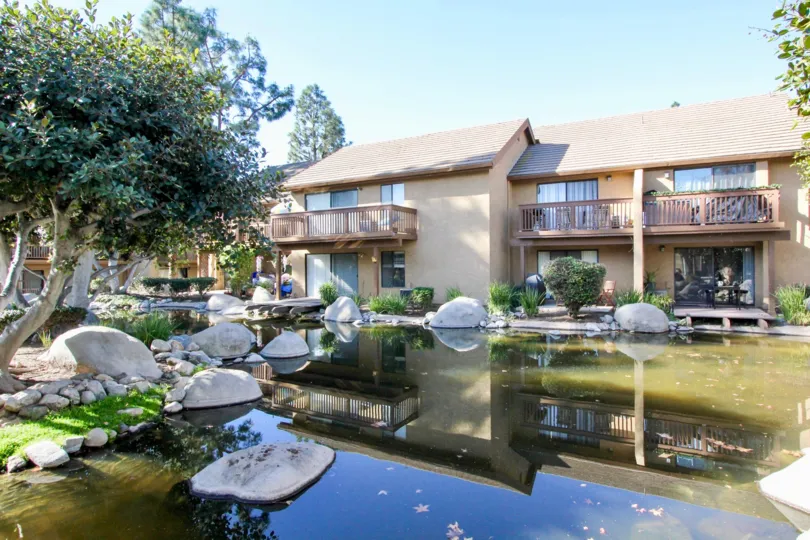 a warm day in the orangetree lake condos with a building that has water and stones and roofless top