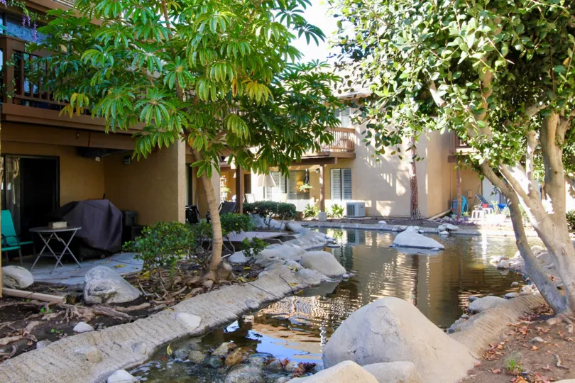 Enjoy patio views and whispering ponds at Orangetree Lake Condos in Irvine.