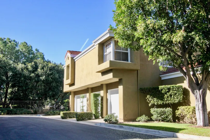 A beige house on a sunny day in the Oxford Court community of Irvine California