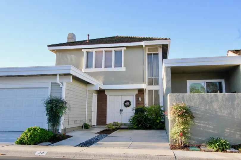 A house with massive entrance with car parking at Park Home, Irvine California