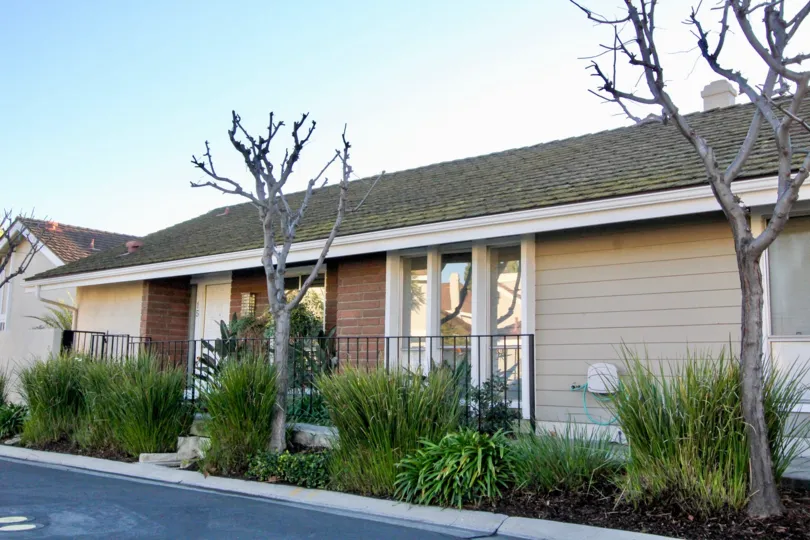 view of front of house with plants and bare trees in Park Homes community in Irvine, California