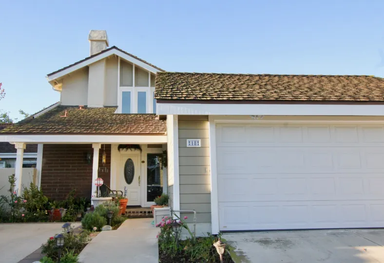 a pleasant day in the park homes with a building that has roofless top and parking door closed and entrance garden