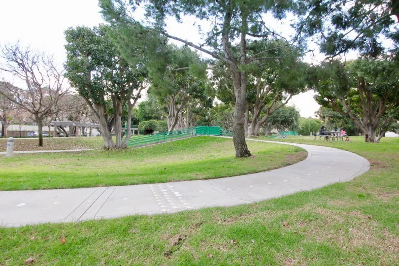 A path and large trees in the park at Park Vista in Irvine, CA