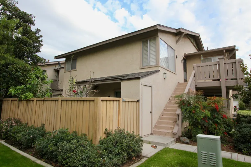 THE VILLA WITH WOODEN STEPS, LOT OF PLANTS WITH FLOWERS, TREES ARE IN PARK VISTA
