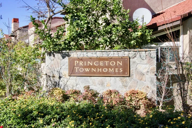 At entrance of the Villa attach a board named as Princeton Townhomes in the wall with plants