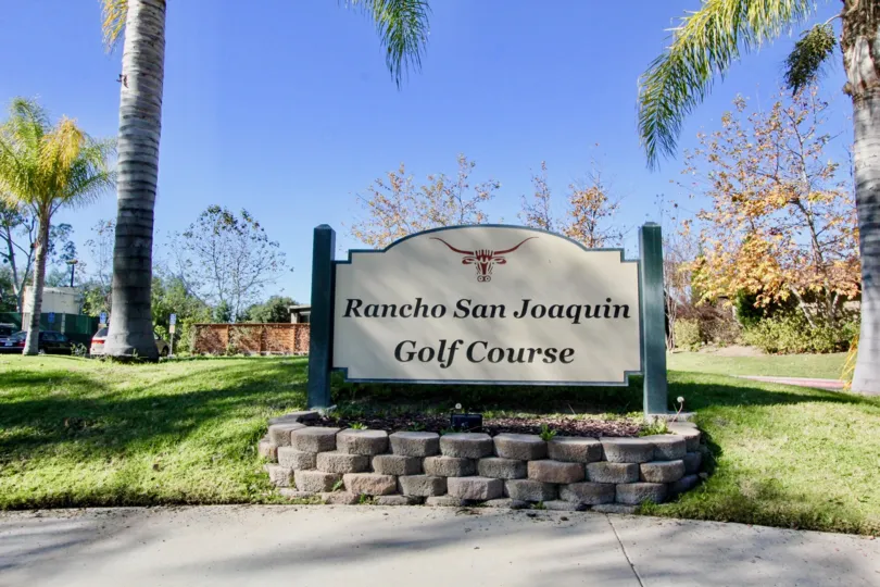 Rancho San Joaquin Golf ground in the Rancho San Joaquin Townhomes with some shrubs, tree and lawn.