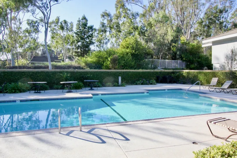 Apartment in Ridge Garden Homes has swimming pool with seating chairs