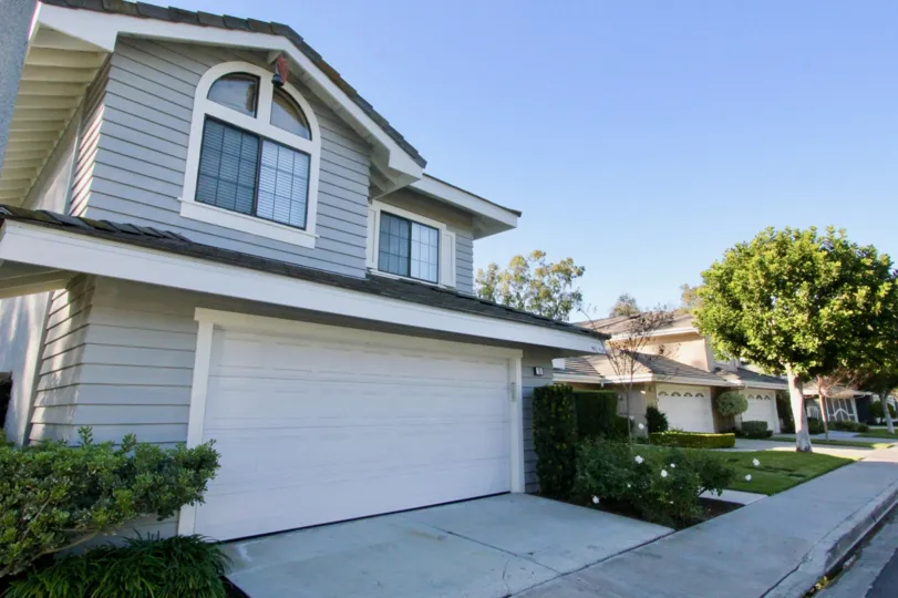 A sunny day in the area of Ridge Garden Homes, outside, windows, garage, tree, driveway