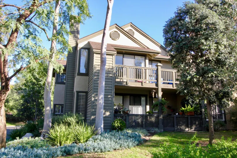 Tall trees with bushes and plants placed near to the villa in Ridge Townhomes Akins