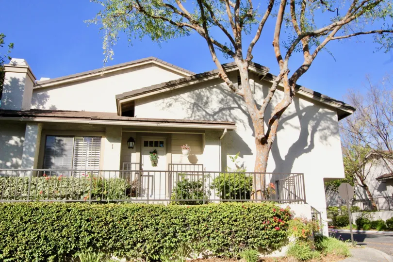 a sunny day in the ridge with a house that has numbered as 1 and has a tree that is situated above the steps