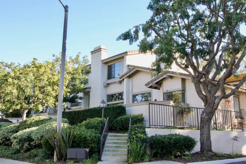 Awesome view of villa with steps and trees in Ridge Townhomes Bren of Irvine