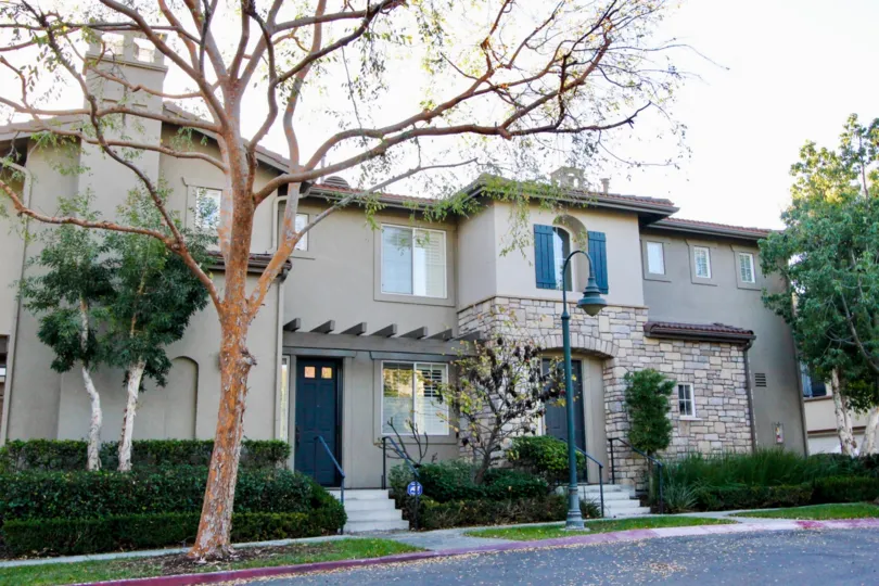 An elegant two-storey residence in San Juan Bautista community with blue doors and shutters.
