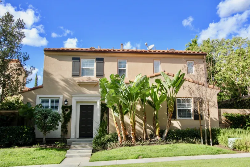 Brown home with tiles and large palm trees in San Simeon, Irvine CA