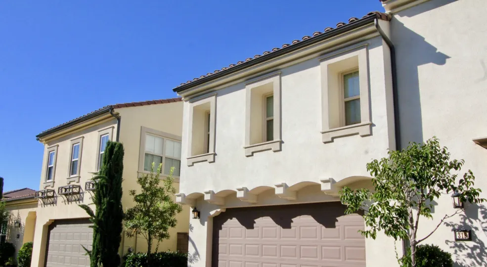 Two homes with garages on a sunny day in the Santa Cruz neighborhood of Irvine, California