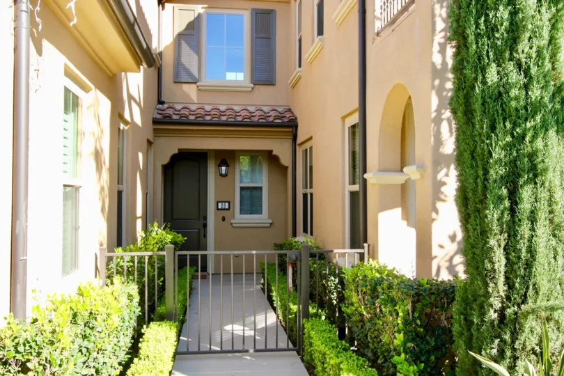 Beautiful sunshine with entrance gate of a villa with green bushes in Santa Rosa of Irvine