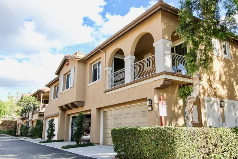 tan townhomes with large balconies and garages in Sheridan Place