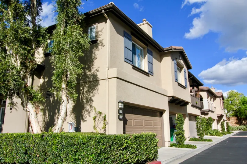 A street lined with town homes with attached garages inside Sheridan Place in Irvine CA