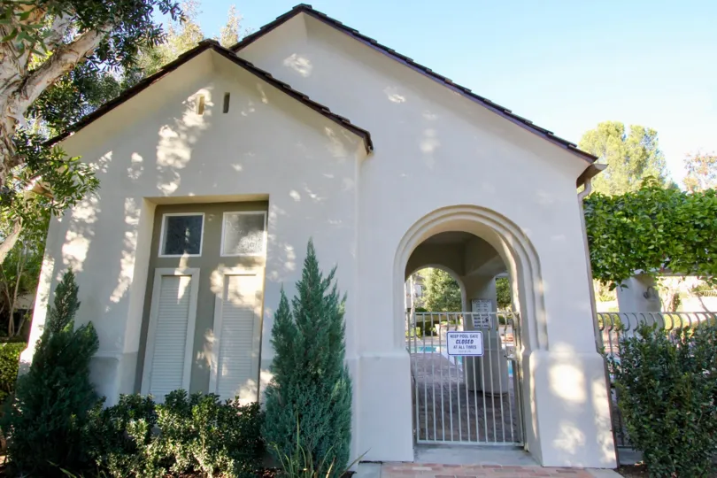 A simple bungalow in the Summit Towne Collection community with gable roof and arched entryway.