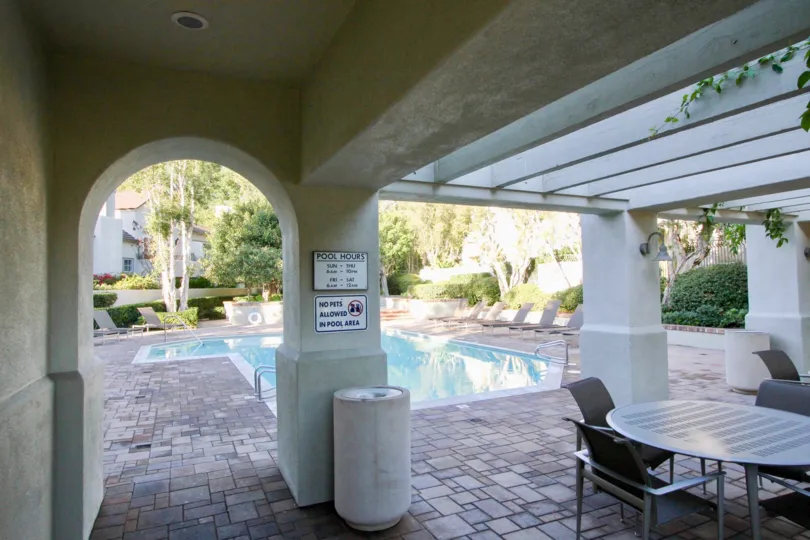 a suuny day in the summit towne collection with building that has clear blue water and resting tables