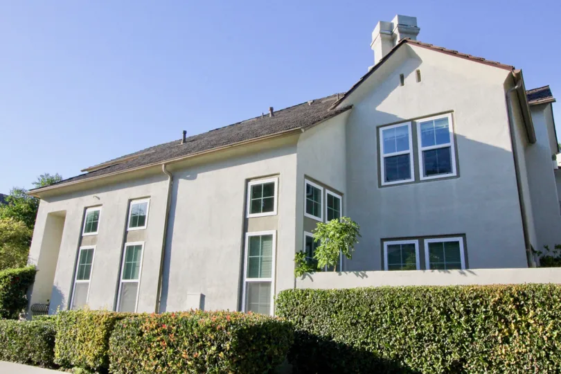 THIS IMAGE SHOWS THE SIDEVIEW OF HOUSE, LOT OF CROTON PLANTS ARE THERE IN IRVINE CITY