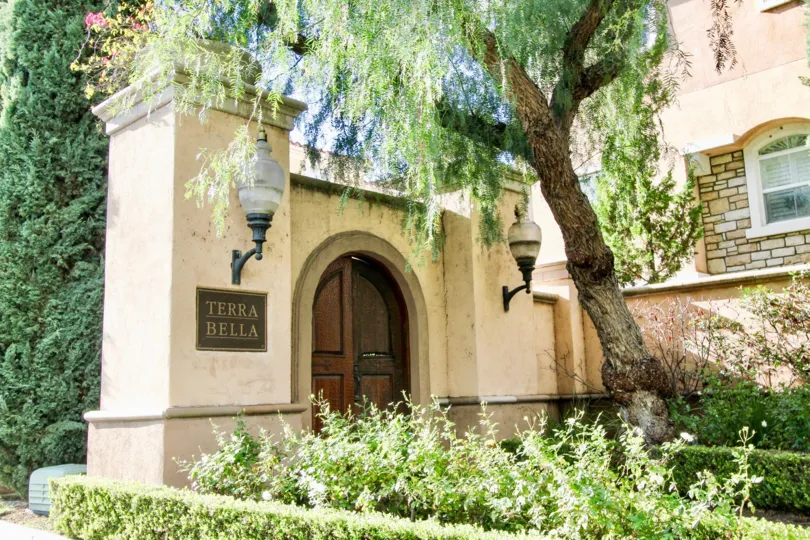 Nice wooden front door and trees with nameplate and lamps in Terra Belta of Irvine