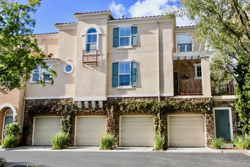 clean and clear area view in front garage near house having trees and plants around in Terra Bella