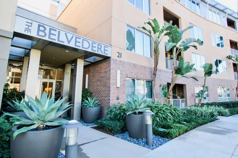 THIS IMAGE SHOWS THE FLATS WITH THE NAME BOARD, EACH SIDE PLANTS ARE THERE IN IRVINE CITY