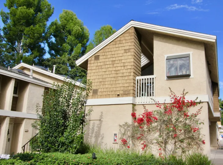 A sunny day in the area of The Lakes, outside, condo, balcony, roof, trees, sky