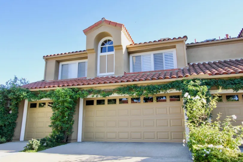 A couple of driveways leading up to attached garages trimmed in ivy at Turtle Rock Pointe in Irvine CA
