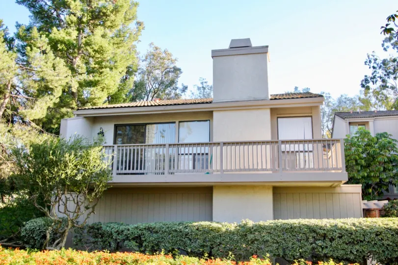 A white house with many windows and a large chimney is in Irvine California.