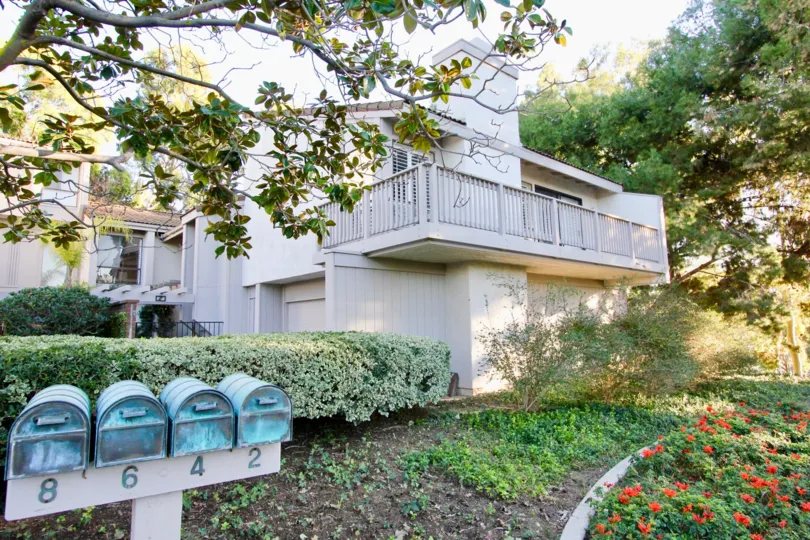 A two-storey residence in Turtle Rock Vista community painted in white.