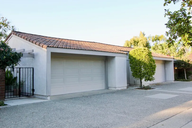a sunny day in Turtle Rock Vista with a concrete driveway and red-roofed garage