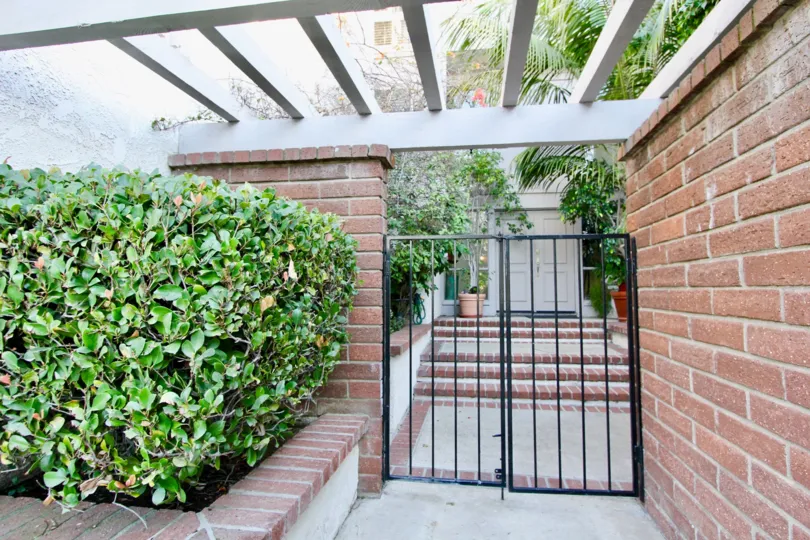 A gated entry to a home in Turtle Rock Vista surrounded by greenery