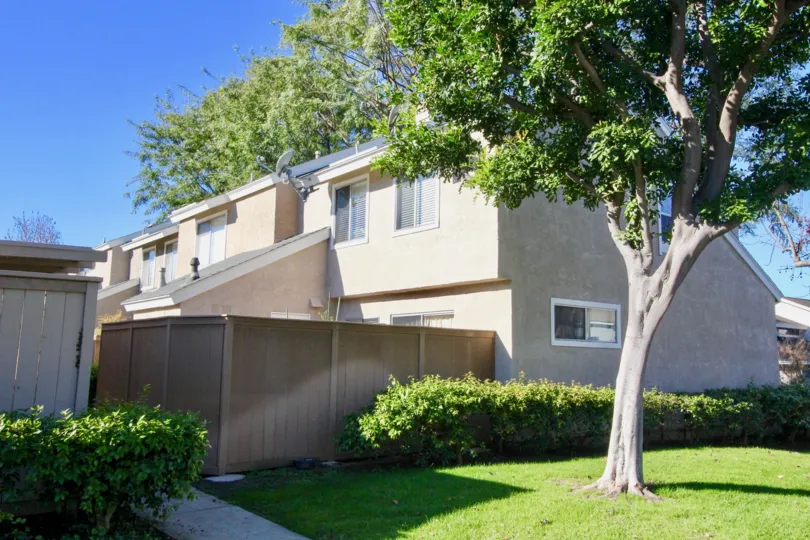 A sunny day in the area of Village Glen, outside, condo, fence, window, tree, sky