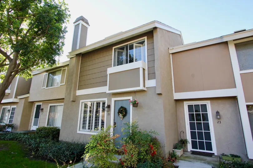 A two-storey unit in Village Glen community painted in white and brown.