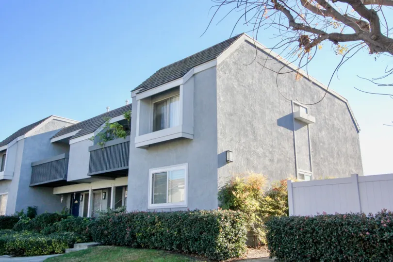 A two-storey townhouse unit in Village Green with gray stucco walls