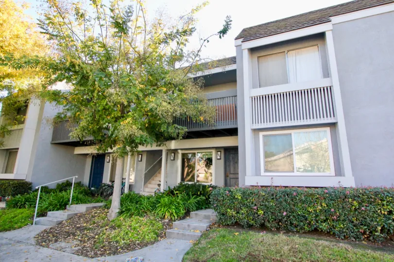 The entrance to homes in Village Green showing landscaping and balconies
