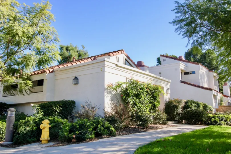 A street view of a home and landscaped yard on a sunny day at the Villas at RSJ