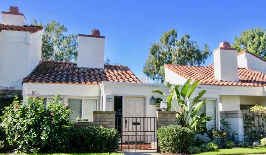 A street view of a home and landscaped yard on a sunny day at the Villas at RSJ