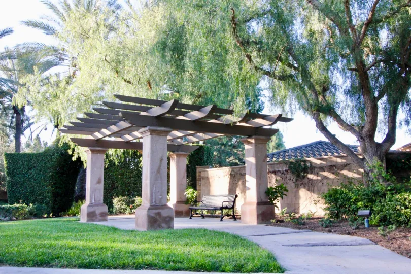 Japanese looking gate and wall with trees in garden in Vinters Reserve, Irvine CA