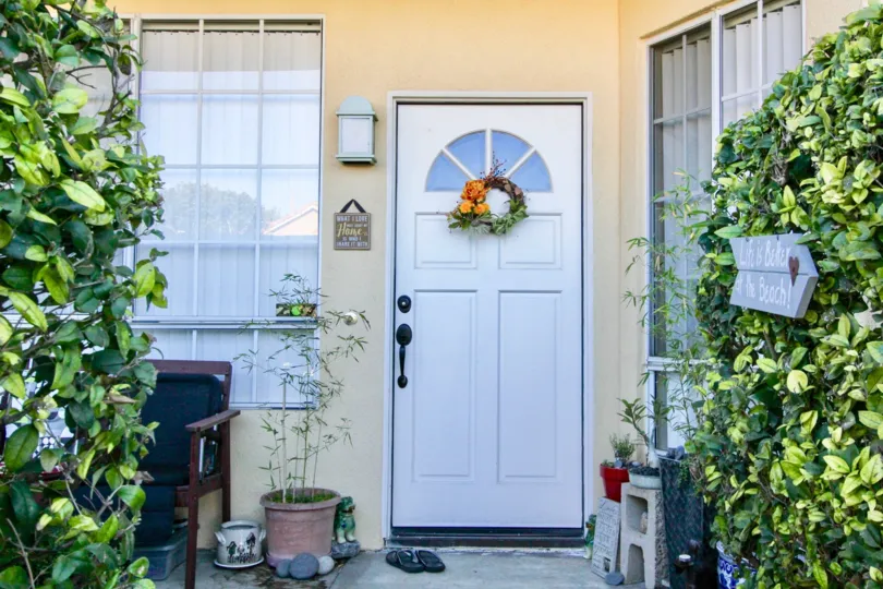The home in vista west park with beautiful front door and lots of plants, chair