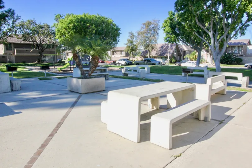 A paved park in the Walnut Square community with concrete seating.