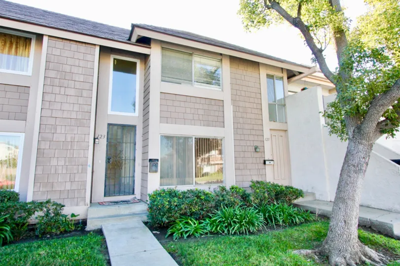 An entry to a home in Walnut Square showing the unit and landscaping