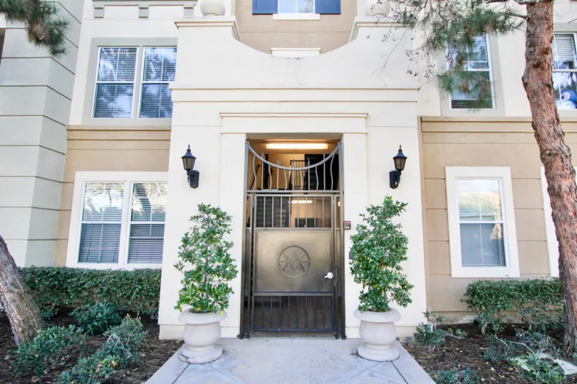 An ornate facade in the Watermarke community with ornate front gate.
