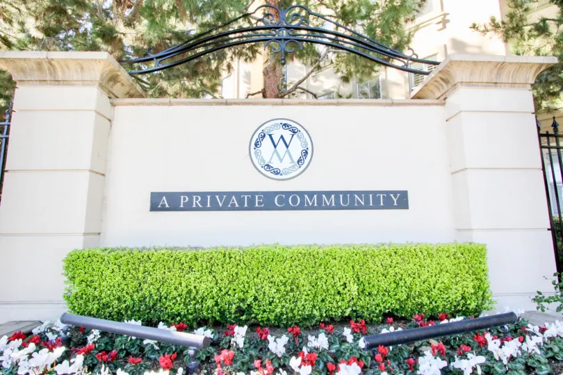 An elegant signage in Watermarke community with steel decor and healthy entourage.