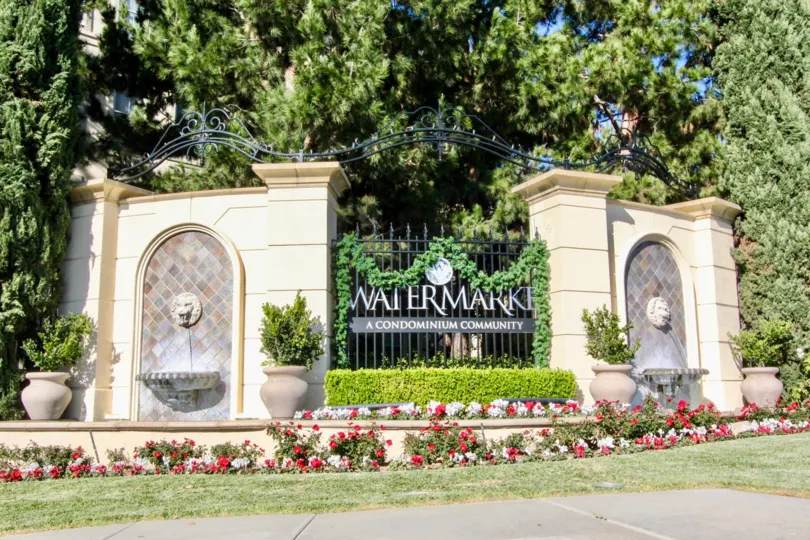 A sunny day in the area of Watermarke, entrance, condos, balcony, trees, windows