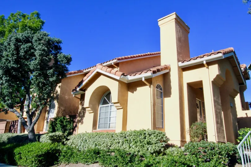 A street view of a home and landscaped yard on a sunny day in Westpark Tiempo
