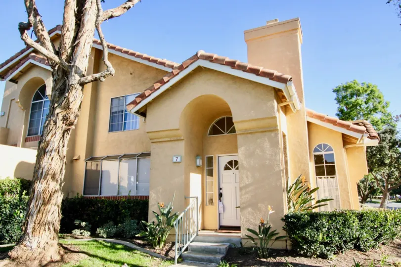 Stairs with white railing leading to home entrance at Westpark Tiempo in Irvine CA