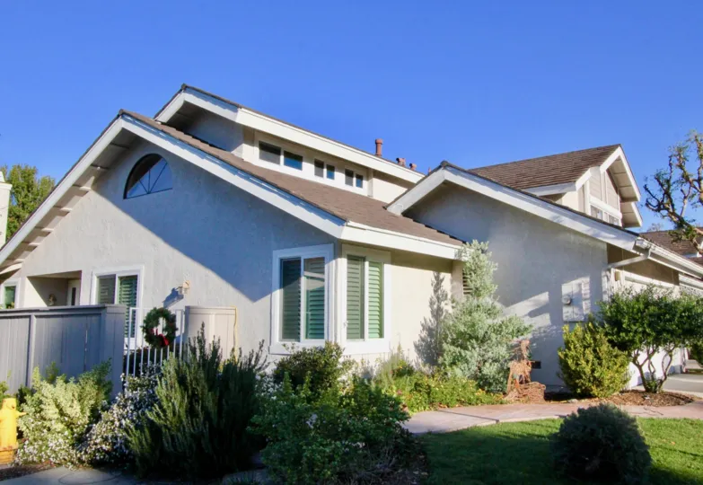Side view of a home and its landscaped yard on a sunny day in Willow Creek